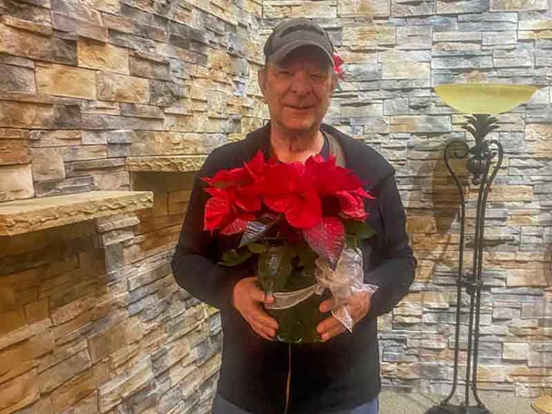 Richard-Johnson-received-his-poinsettia-from-our-Christmas-Service-Bell-Mortuary_800x600